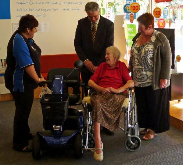 Gwen Nash receives her new mobility scooter during the award ceremony.